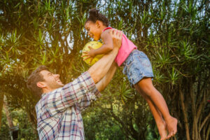 father lifting daughter