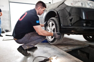 car repair maintenance theme mechanic uniform working auto service checking tyres