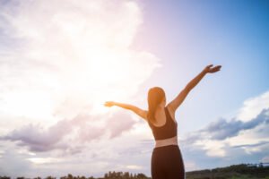 happy smiling athletic woman with arms outstretched 1