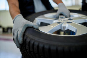 closeup mechanic working with car tire auto repair shop